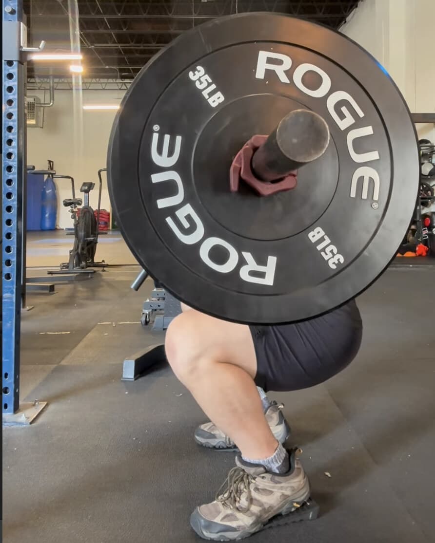 Barbell back squat in the Diamond Heart Strength Room in Bushwick, Brooklyn