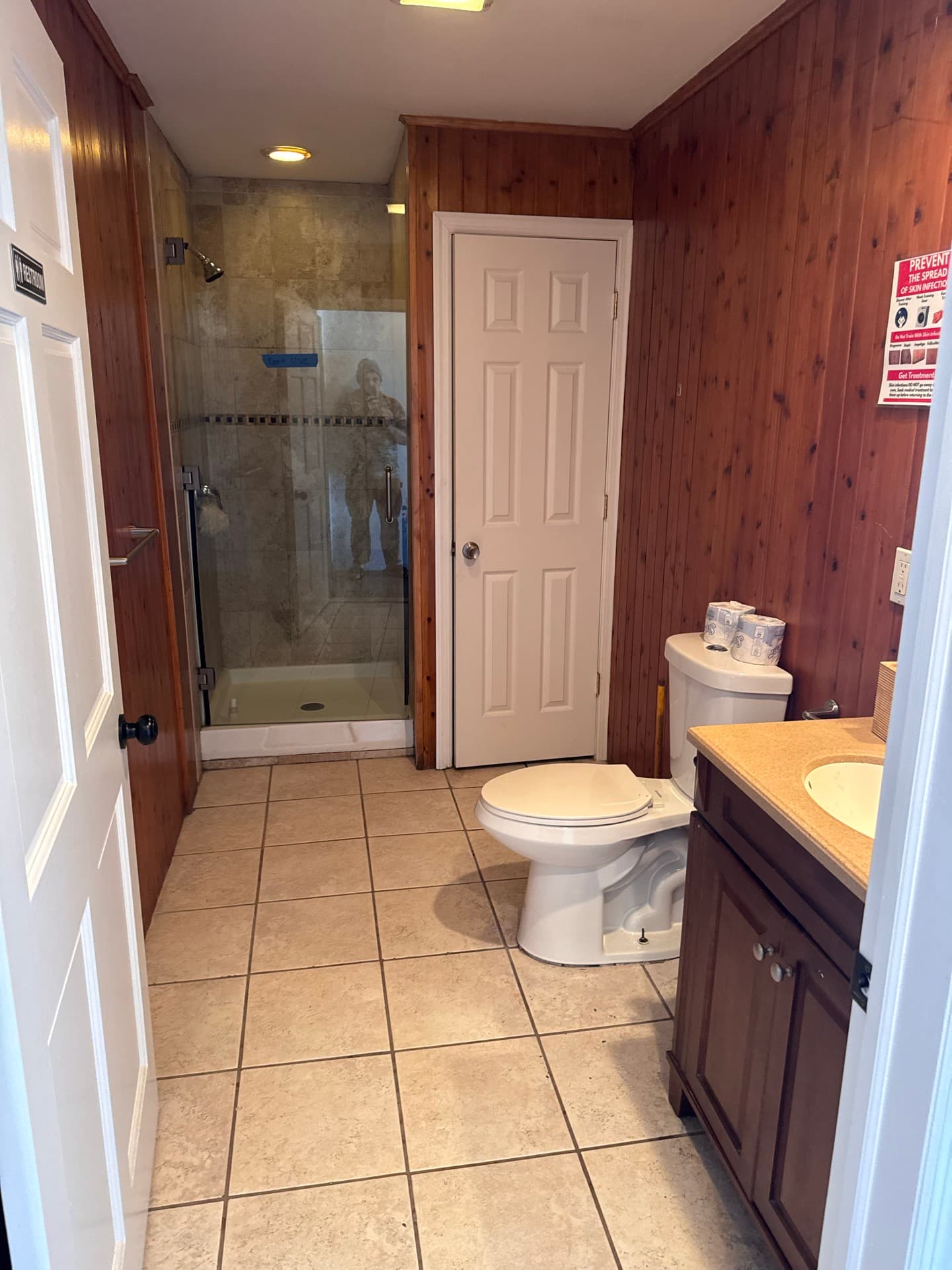 Private shower with glass door and tiled bathroom