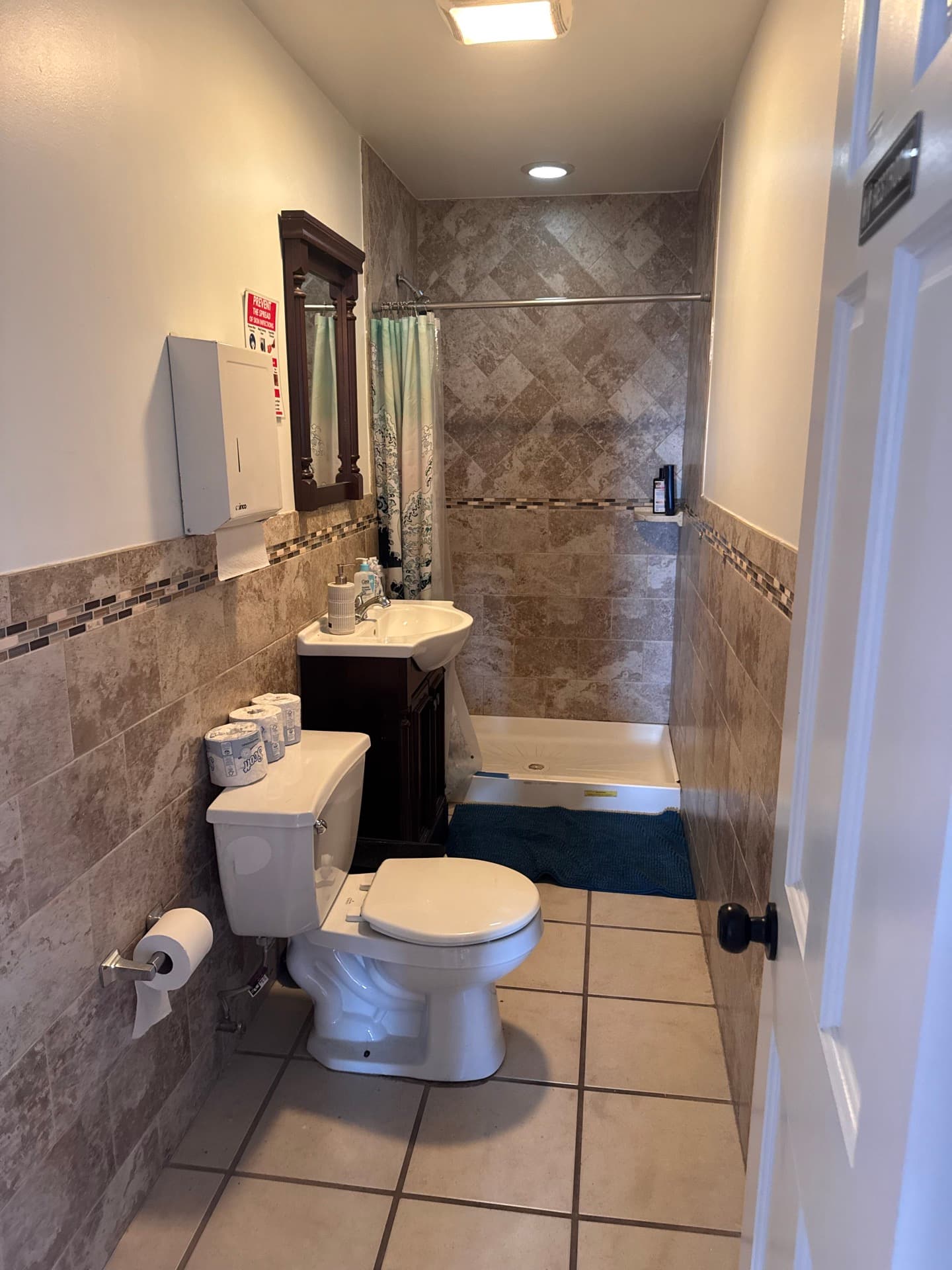 Full bathroom with walk-in shower and tiled walls