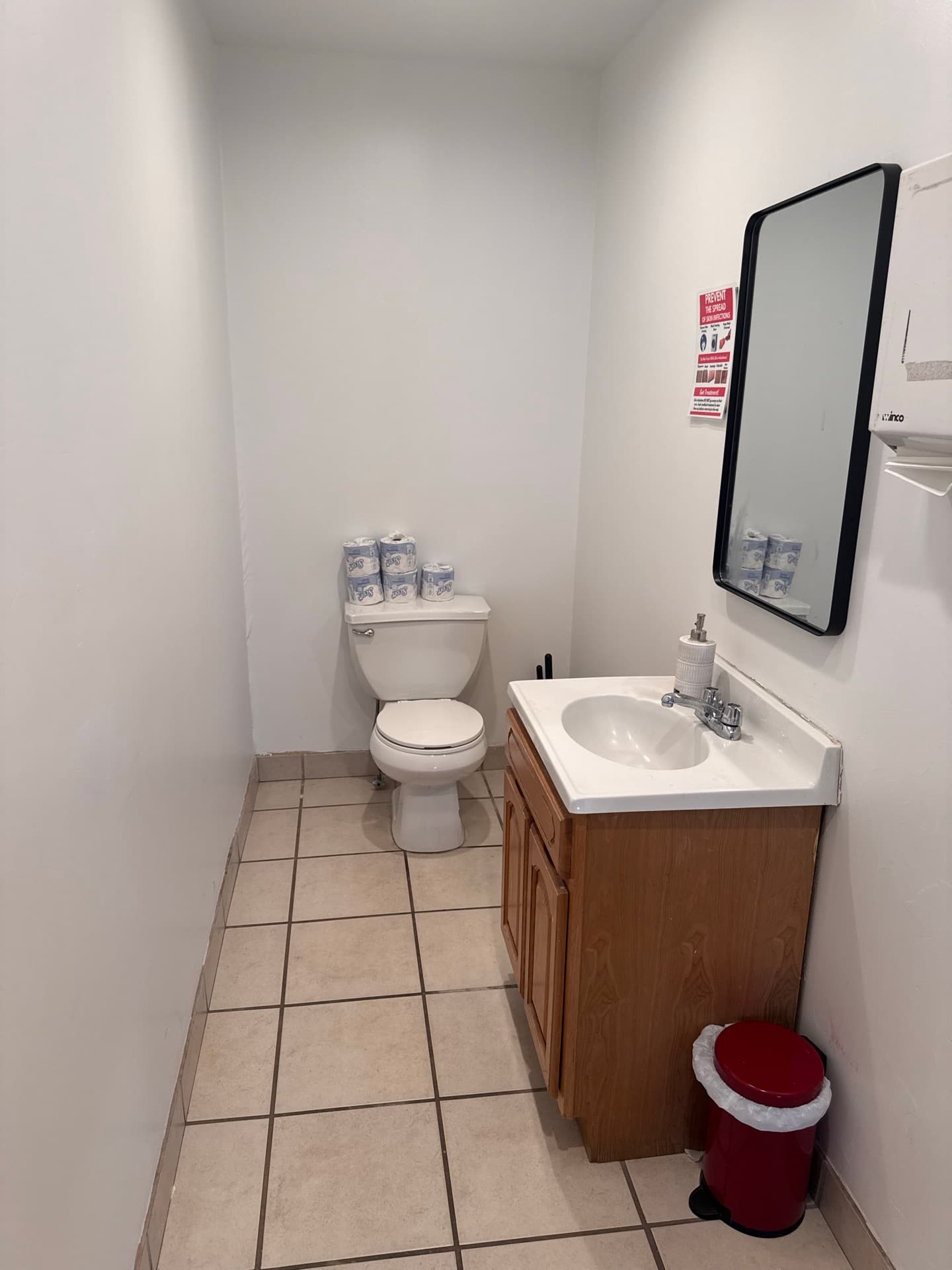 Restroom with vanity mirror and tiled floor